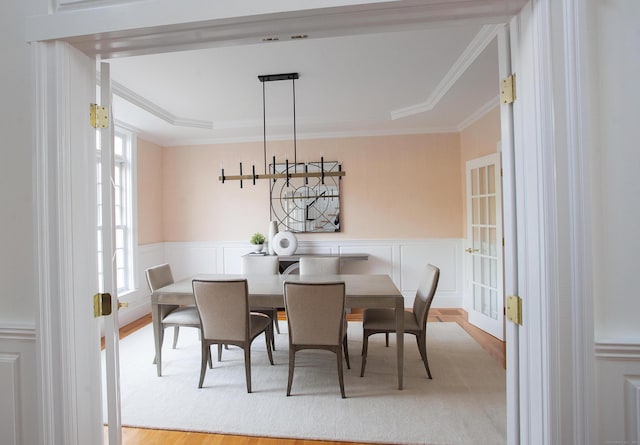 266 Great Plain Rd, Danbury, CT 06811 - dining area featuring wood finished floors, plenty of natural light, crown molding, a decorative wall, and wainscoting