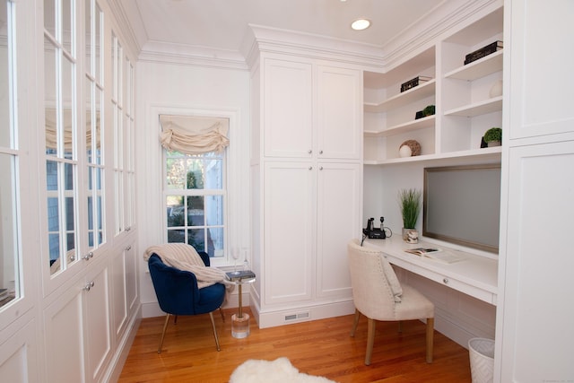 office area with visible vents, ornamental molding, built in desk, recessed lighting, and light wood-style floors