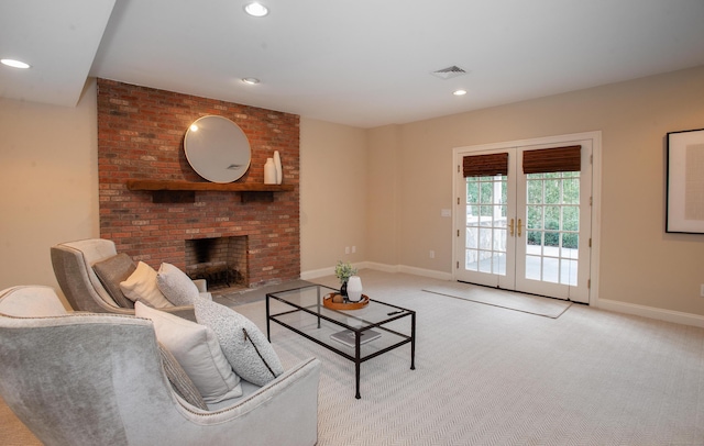 living area with visible vents, baseboards, recessed lighting, french doors, and a fireplace