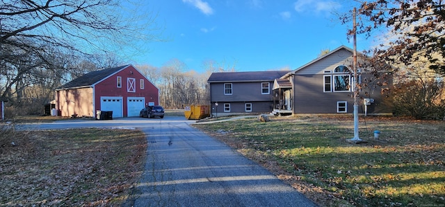 exterior space with a lawn, an outbuilding, and a garage