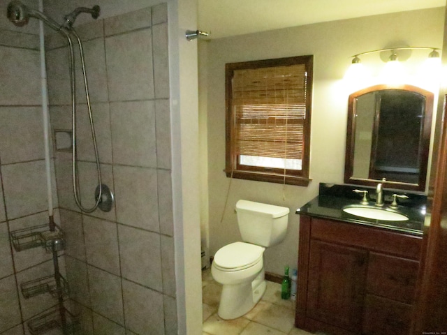 bathroom with toilet, tile patterned flooring, walk in shower, and vanity