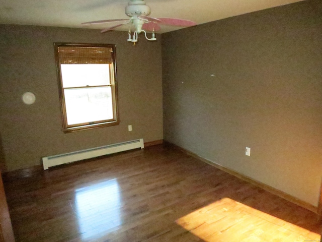 spare room featuring ceiling fan, a baseboard radiator, and hardwood / wood-style floors