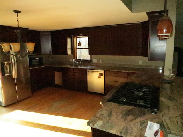 kitchen featuring sink, light wood-type flooring, and appliances with stainless steel finishes