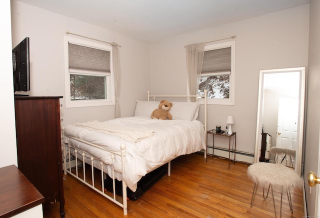 bedroom featuring hardwood / wood-style flooring and a baseboard radiator