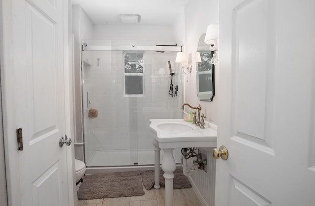 bathroom featuring toilet and walk in shower