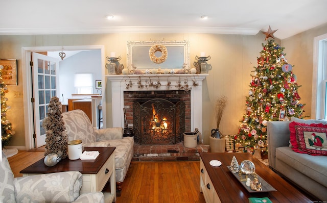 sitting room featuring hardwood / wood-style flooring, crown molding, and a fireplace