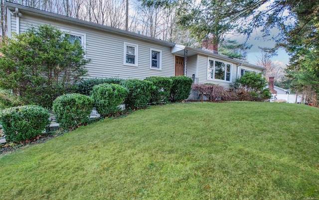 ranch-style home with a front lawn