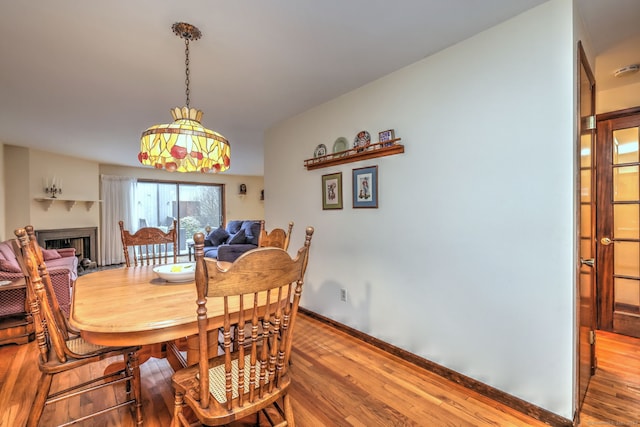 dining space with wood-type flooring