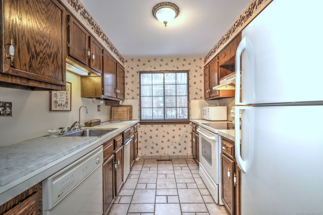 kitchen featuring white appliances and sink