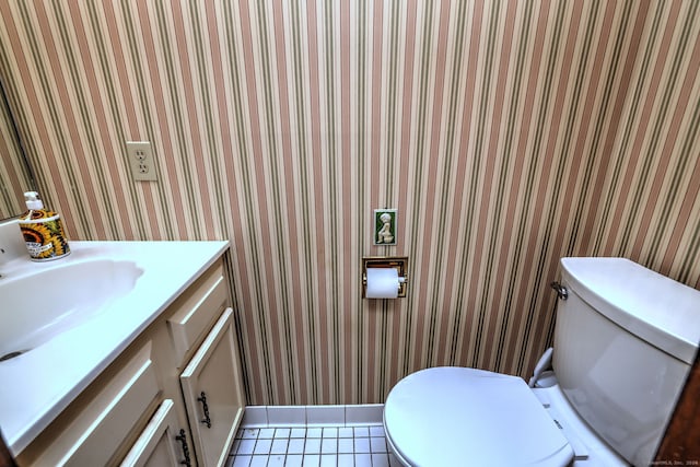 bathroom featuring tile patterned flooring, vanity, and toilet