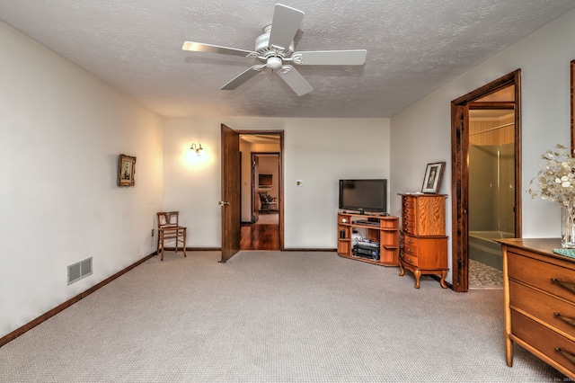 living area featuring ceiling fan, a textured ceiling, and light carpet