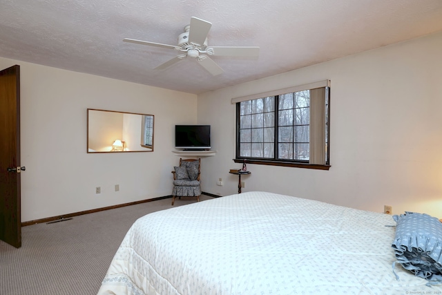 bedroom with carpet flooring, a textured ceiling, and ceiling fan