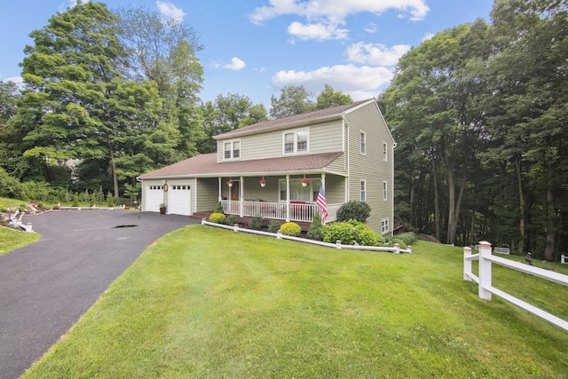 view of front of house featuring a porch, a garage, and a front lawn