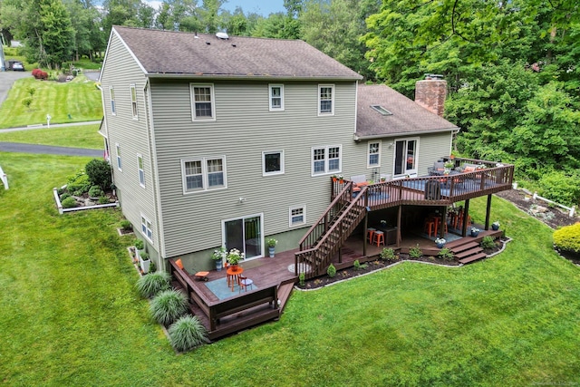 back of property featuring a yard and a deck