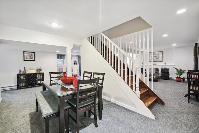 carpeted dining area featuring a baseboard heating unit