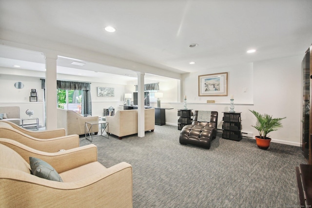 living room featuring a baseboard radiator, decorative columns, and carpet