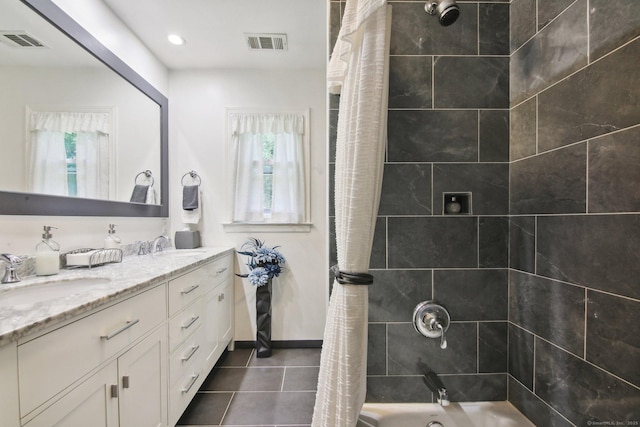 bathroom featuring tile patterned floors, vanity, and shower / bath combo