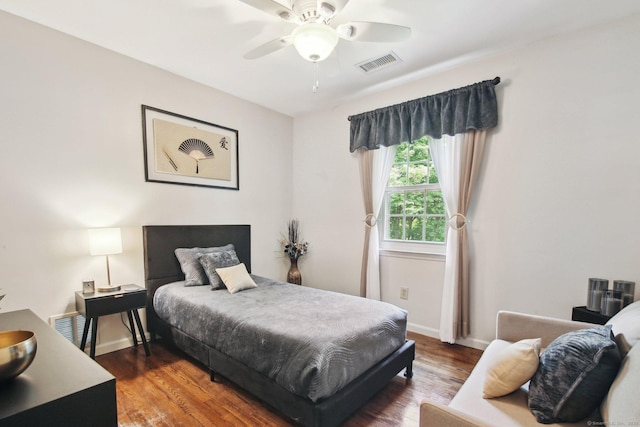 bedroom with ceiling fan and dark hardwood / wood-style flooring