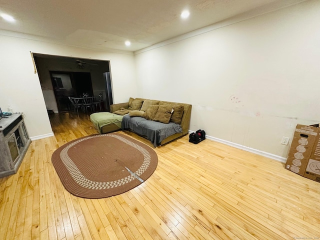 living room featuring light wood-type flooring and ornamental molding