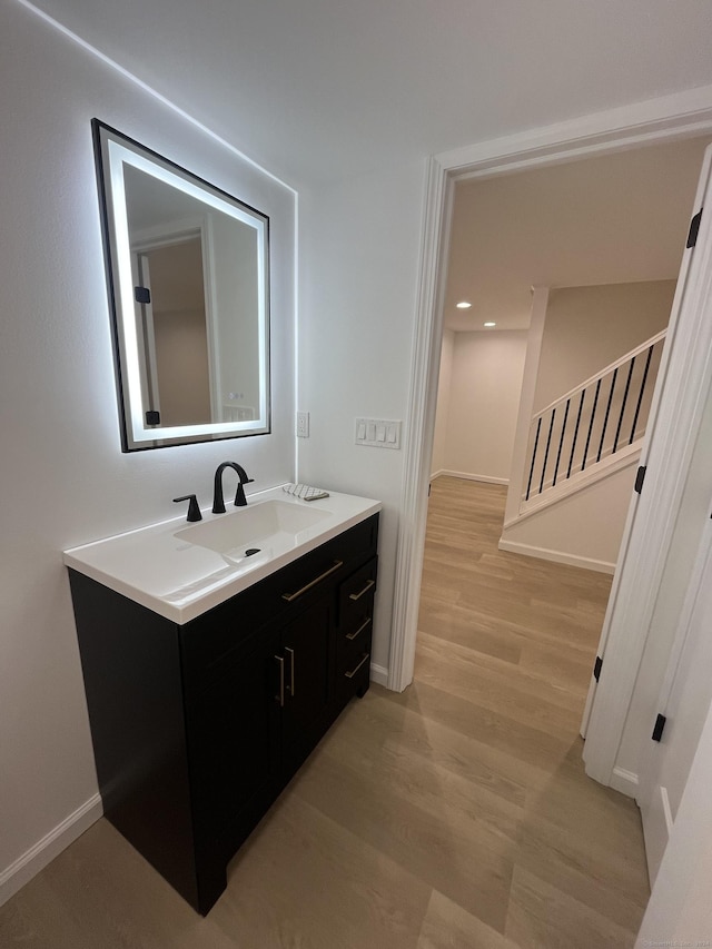 bathroom with hardwood / wood-style floors and vanity