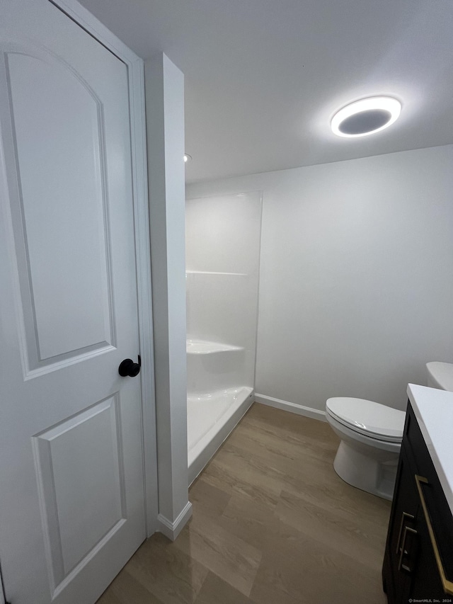 bathroom featuring hardwood / wood-style flooring, vanity, and toilet