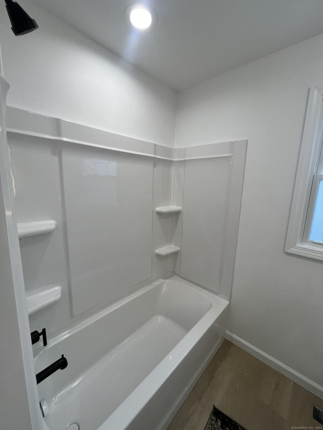 bathroom featuring hardwood / wood-style flooring and shower / tub combination