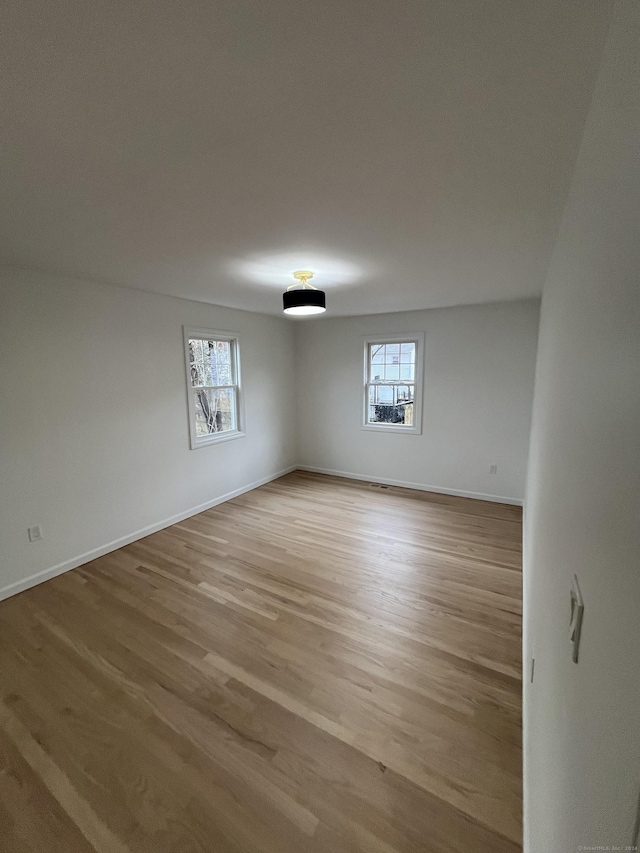 spare room with light hardwood / wood-style floors