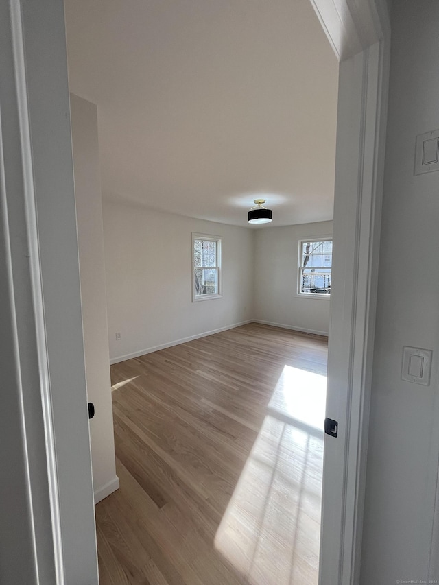 unfurnished room with light wood-type flooring