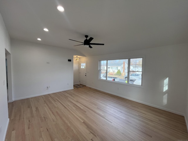 unfurnished living room featuring ceiling fan, lofted ceiling, and light hardwood / wood-style flooring