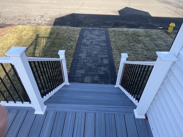 wooden deck featuring a yard