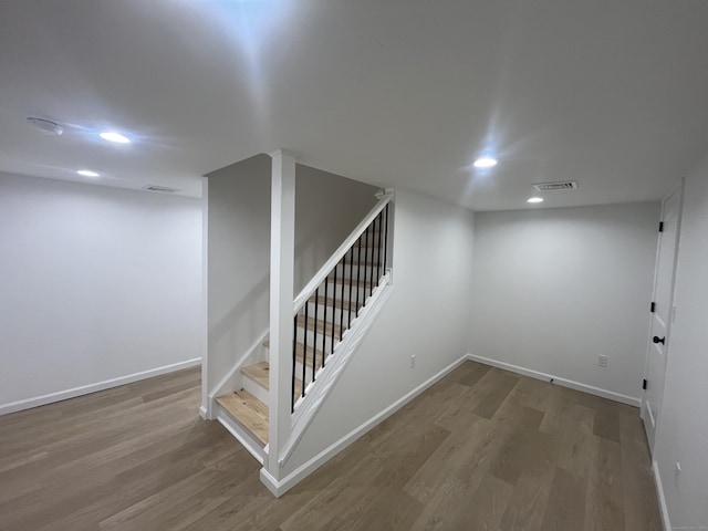 basement with hardwood / wood-style floors