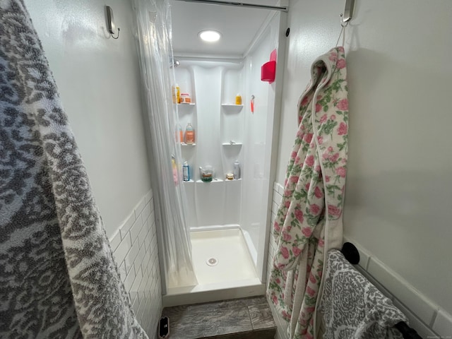 bathroom with crown molding and walk in shower