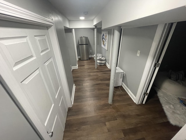 corridor with dark hardwood / wood-style flooring