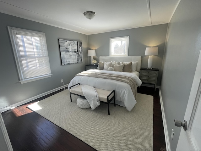 bedroom featuring ornamental molding and dark wood-type flooring