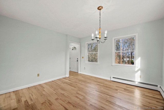 unfurnished dining area featuring a notable chandelier, light hardwood / wood-style flooring, and a baseboard radiator