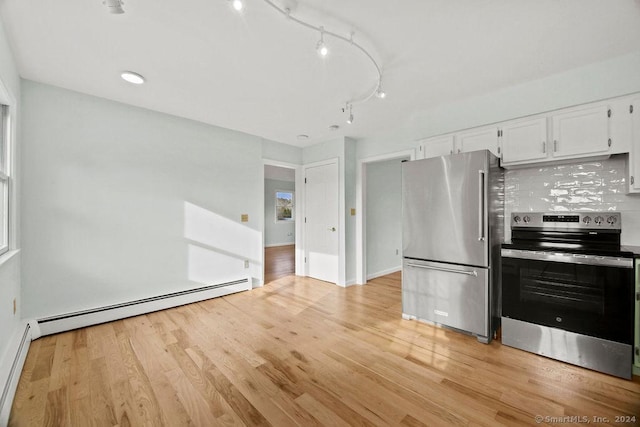 kitchen with tasteful backsplash, light hardwood / wood-style flooring, a baseboard radiator, appliances with stainless steel finishes, and white cabinets