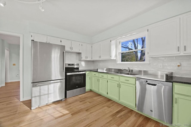 kitchen featuring sink, stainless steel appliances, light hardwood / wood-style floors, white cabinets, and green cabinetry