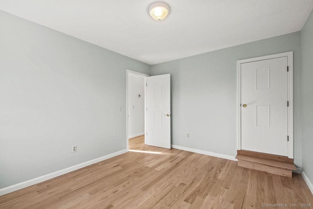 unfurnished bedroom with light wood-type flooring