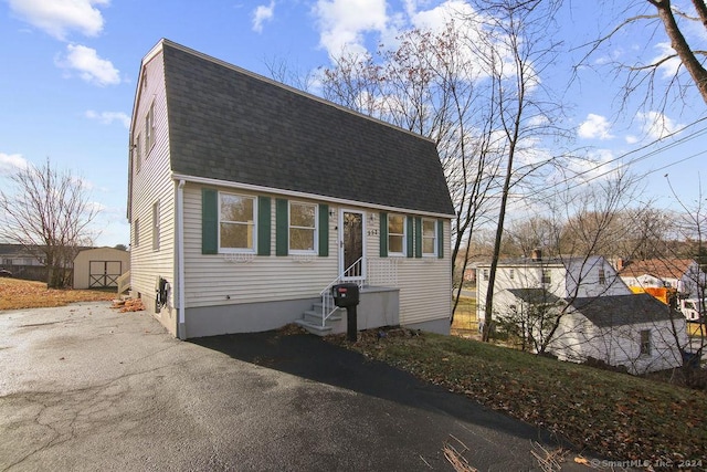 view of front of property with a storage shed