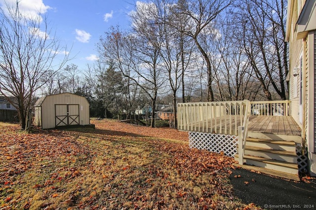 view of yard with a storage unit and a deck