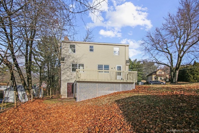 rear view of property with a wooden deck