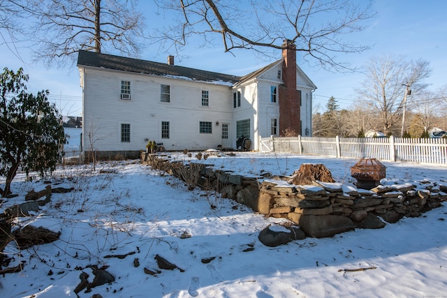 snow covered property featuring an outdoor fire pit