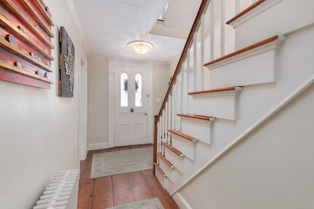 entryway featuring crown molding and hardwood / wood-style floors