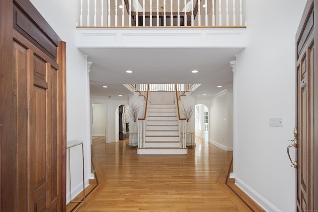 foyer featuring ornamental molding and light wood-type flooring