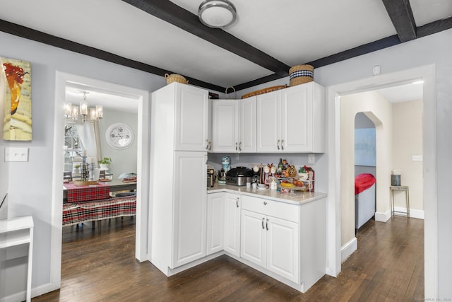 kitchen with beamed ceiling, an inviting chandelier, dark hardwood / wood-style floors, and white cabinetry