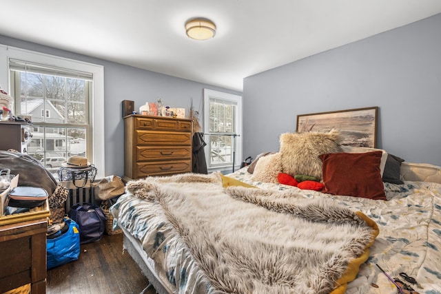 bedroom with dark hardwood / wood-style flooring