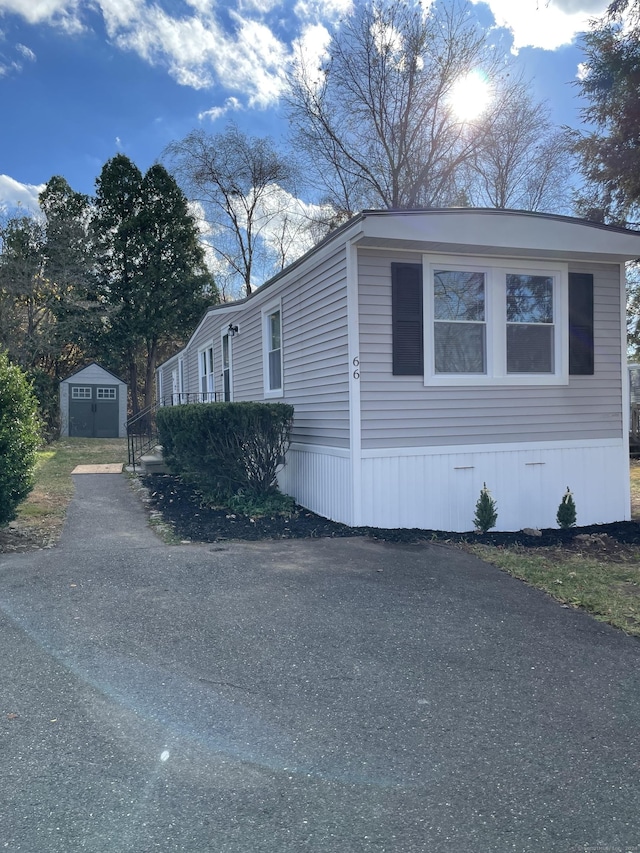 view of home's exterior with a storage unit