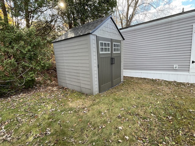 view of outbuilding with a yard