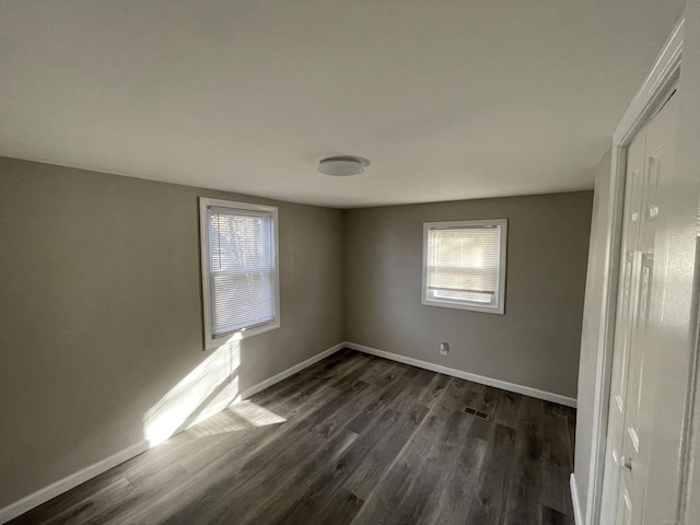 spare room featuring dark hardwood / wood-style flooring