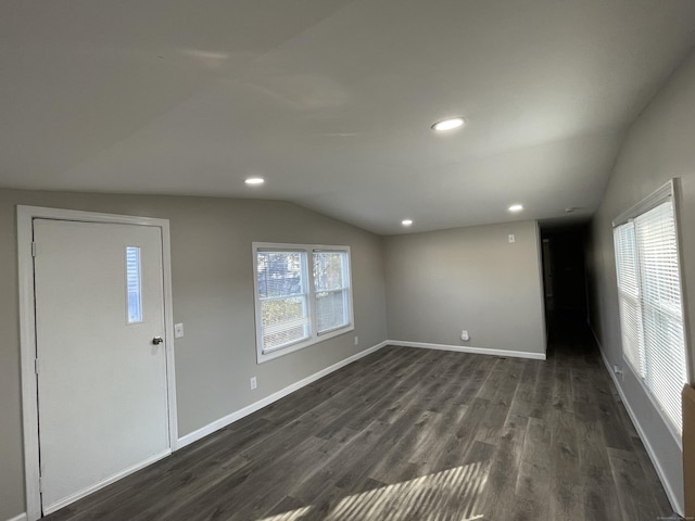 foyer entrance with lofted ceiling and dark wood-type flooring